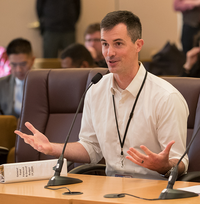 Jeff Renfro, a white, young man with brown hair addresses the Multnomah County Commission